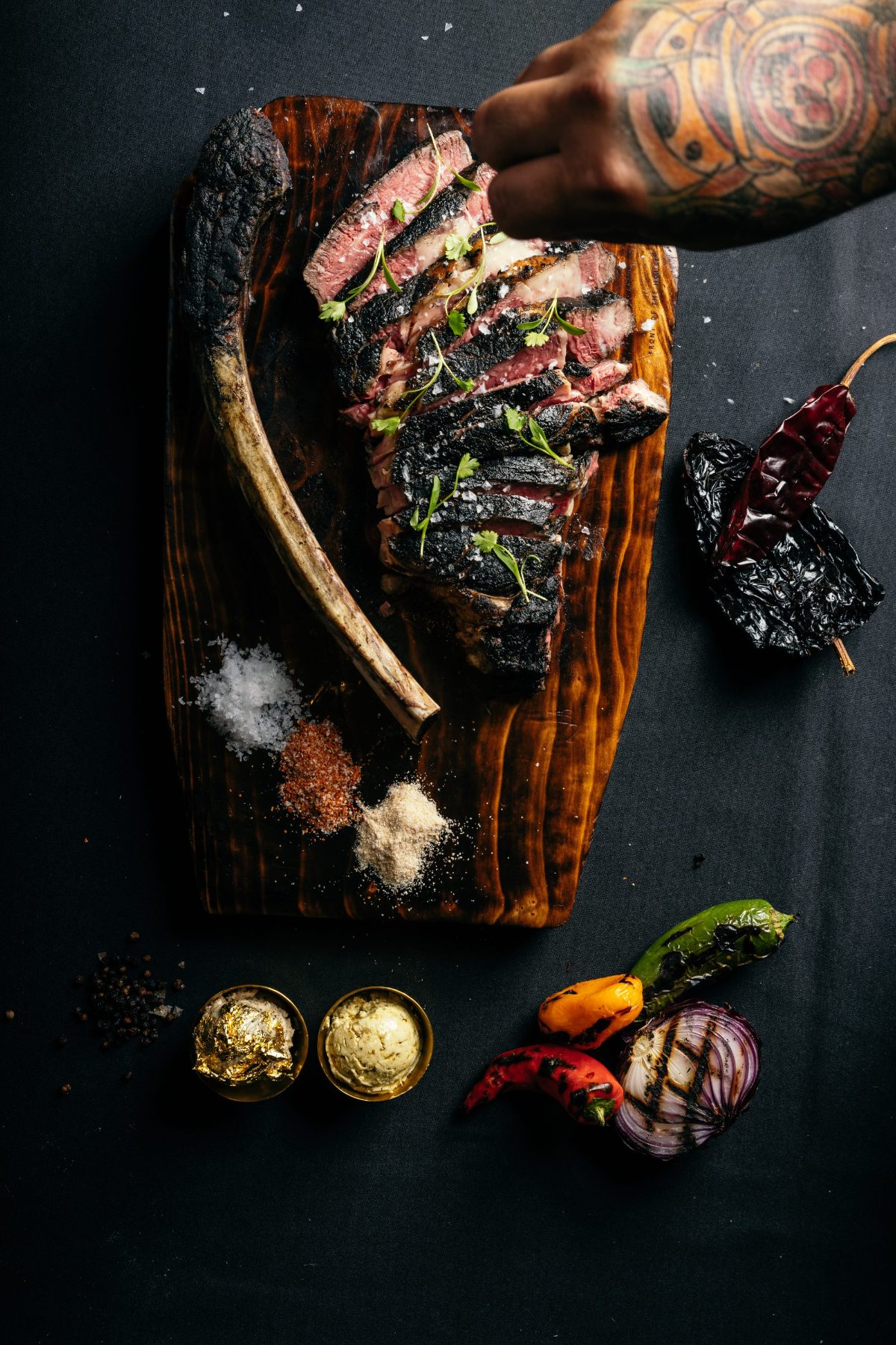 A tomahawk carved on the board with condiments