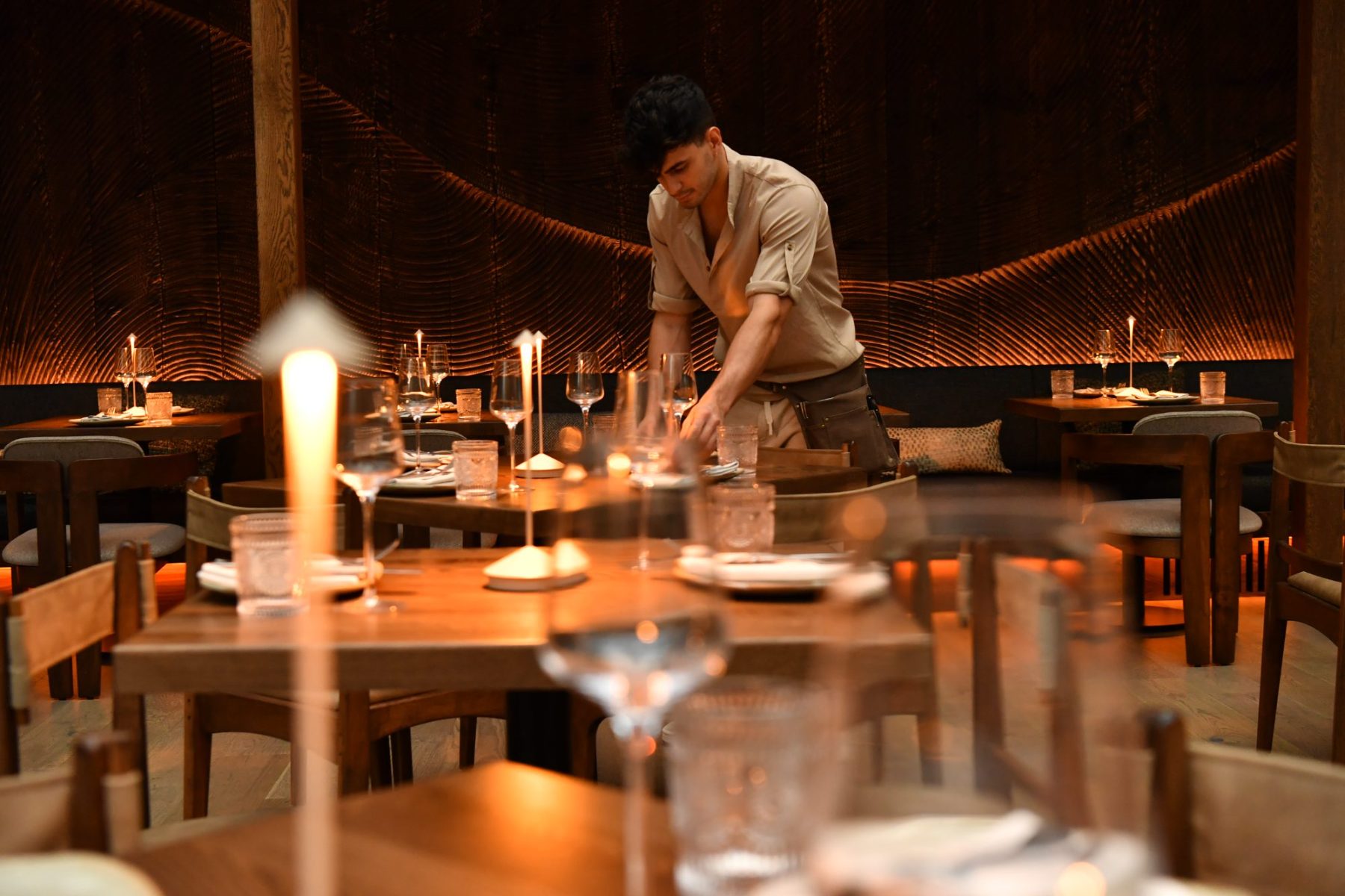 A server setting the room before service